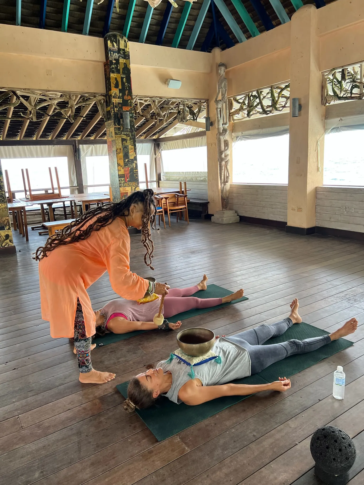 Closing with singing bowls over people in savasana.